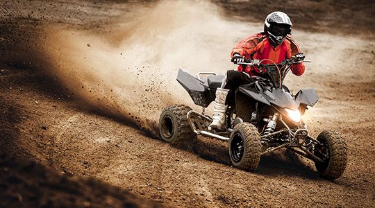 ATV rider turning on a dirt road