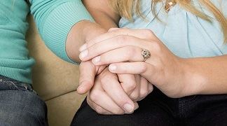 Couple comforting each other after death of loved one